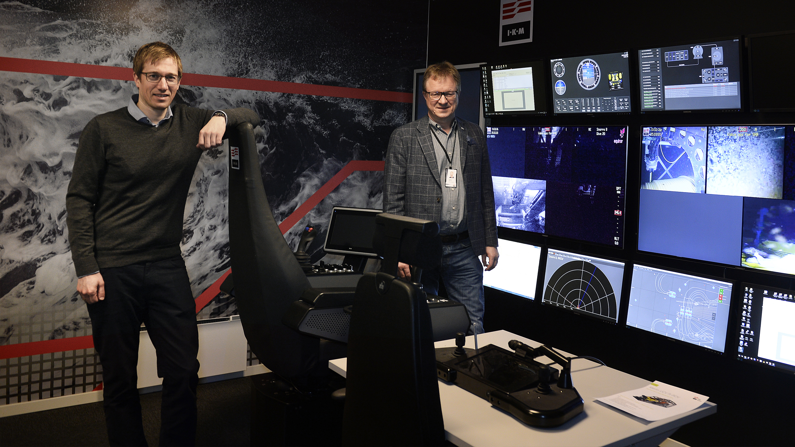Two people in a simulator room