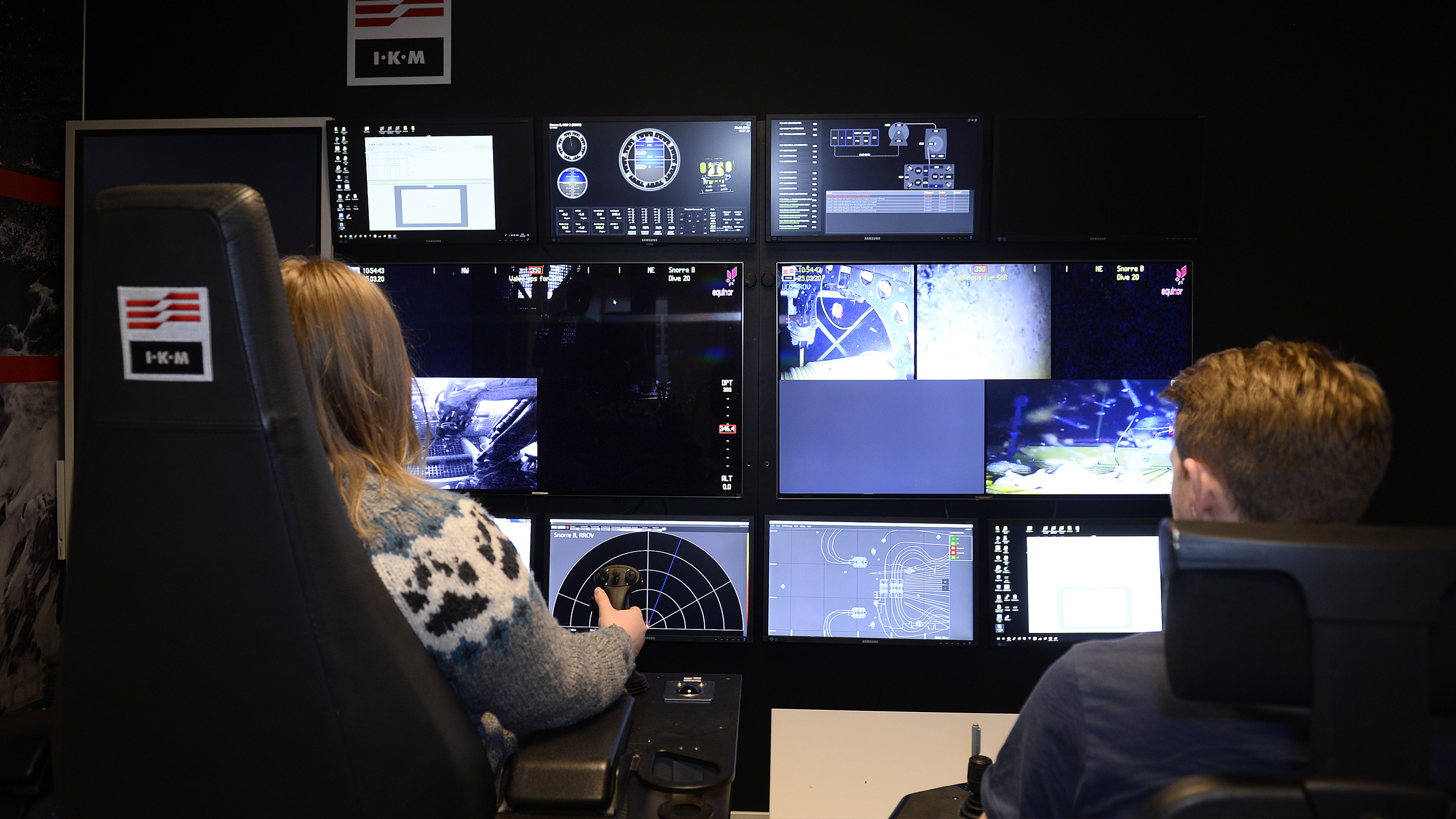 Two people in a simulator room
