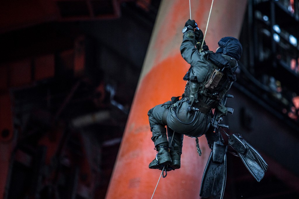 Navy seal entering an offshore facility